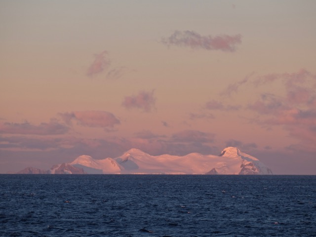 first Antarctic sunset with pink icebergs