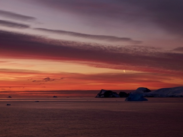 spot the moon amidst the clouds and sunset